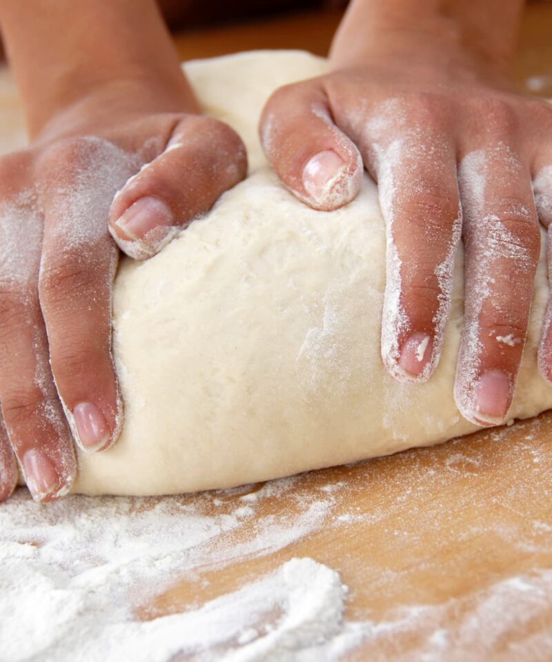 Hands kneading the dough
